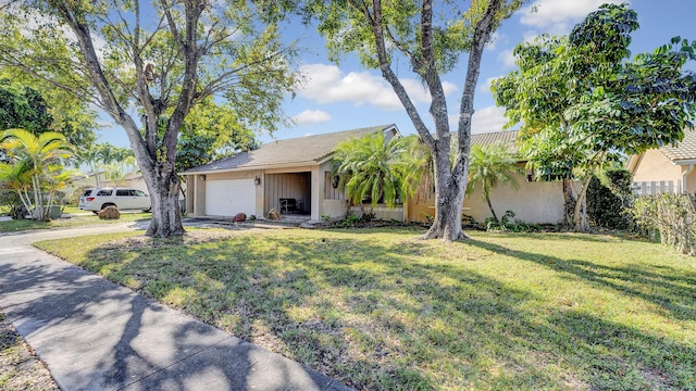 single story home featuring a front yard and a garage