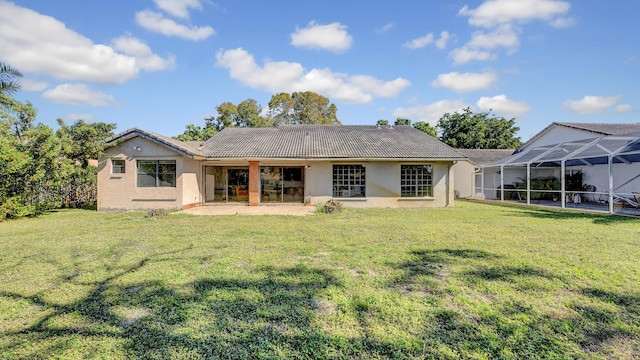 back of house featuring a patio, a yard, and glass enclosure