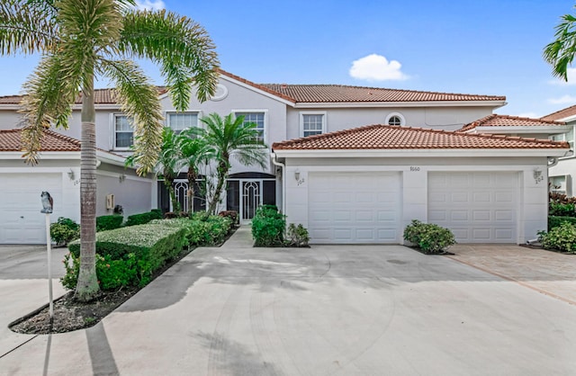 mediterranean / spanish-style house with a garage