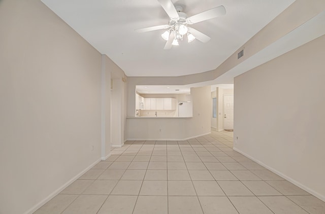 unfurnished living room featuring light tile patterned flooring and ceiling fan