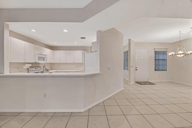 kitchen with white appliances, hanging light fixtures, a notable chandelier, white cabinets, and kitchen peninsula