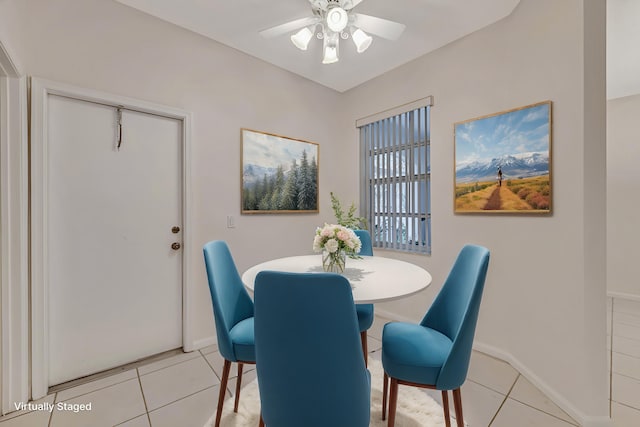 dining area with light tile patterned floors and ceiling fan