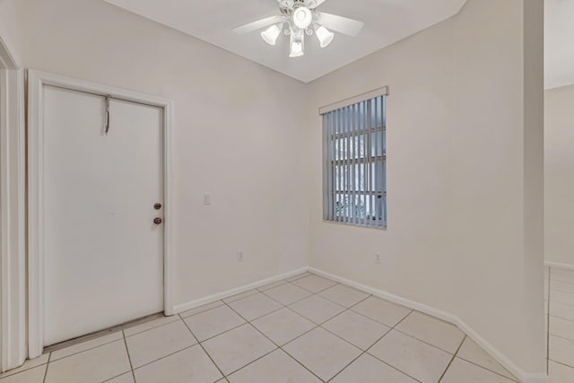 spare room featuring light tile patterned flooring and ceiling fan