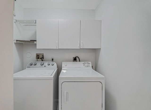 laundry room with cabinets and washing machine and dryer