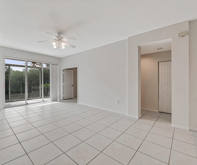 spare room with ceiling fan and light tile patterned floors