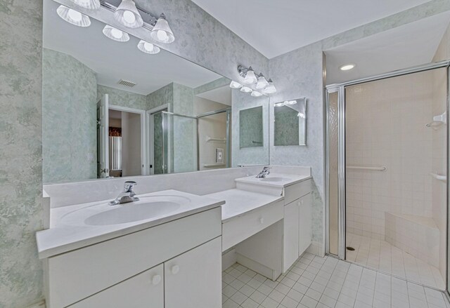 bathroom with vanity, a shower with shower door, and tile patterned flooring