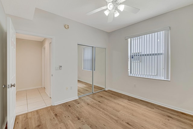 unfurnished bedroom with a closet, ceiling fan, and light hardwood / wood-style flooring