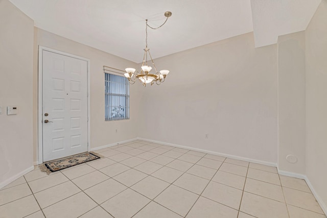 tiled empty room with a notable chandelier