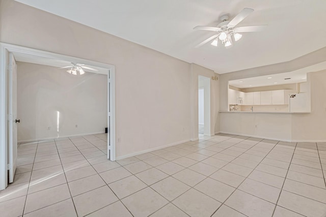 empty room featuring light tile patterned floors and ceiling fan