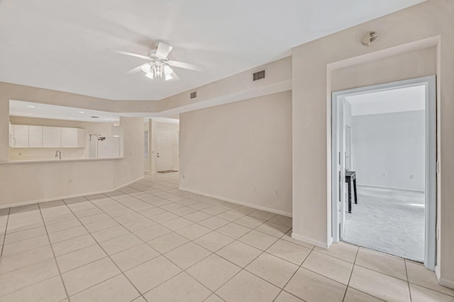 tiled spare room featuring ceiling fan