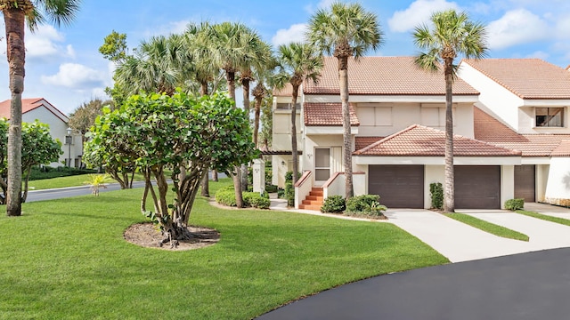 view of front of home with a garage and a front lawn