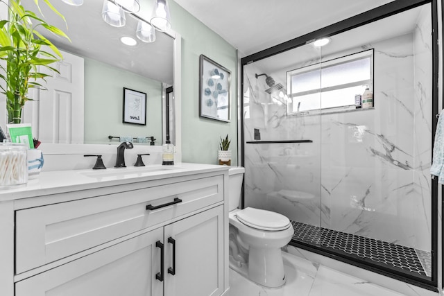 bathroom featuring vanity, toilet, and a shower with shower door