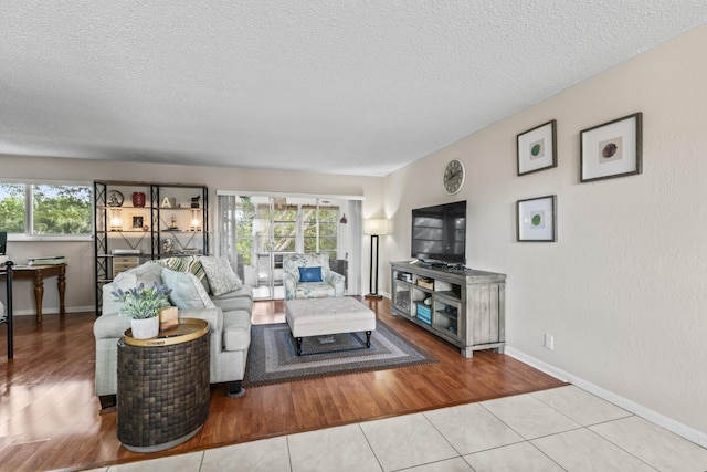 tiled living room with a healthy amount of sunlight and a textured ceiling