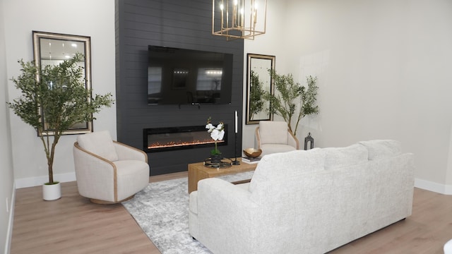 living room with hardwood / wood-style flooring and a large fireplace