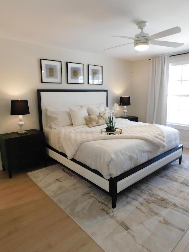 bedroom featuring light wood-type flooring and ceiling fan