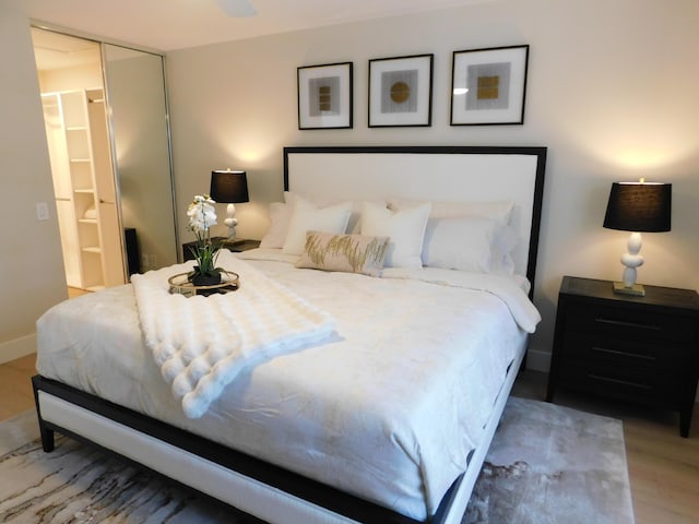 bedroom featuring wood finished floors and baseboards