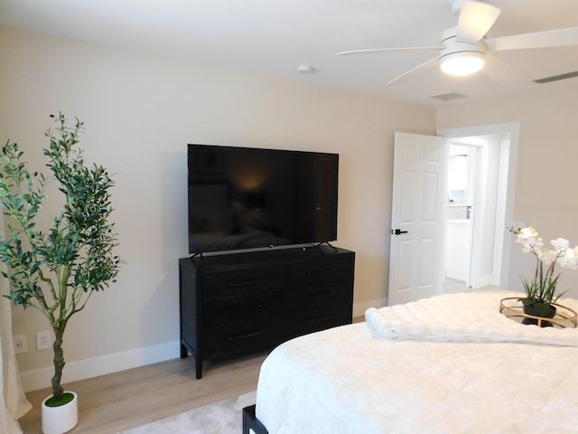 bedroom featuring visible vents, light wood-style flooring, a ceiling fan, and baseboards