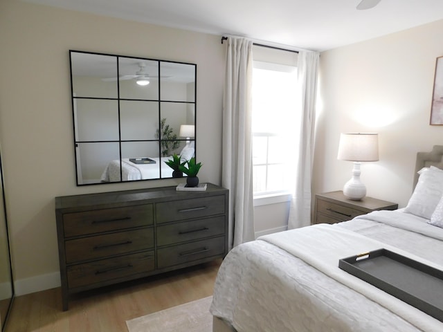 bedroom with light wood-style flooring and baseboards