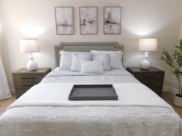 bedroom featuring baseboards and wood finished floors