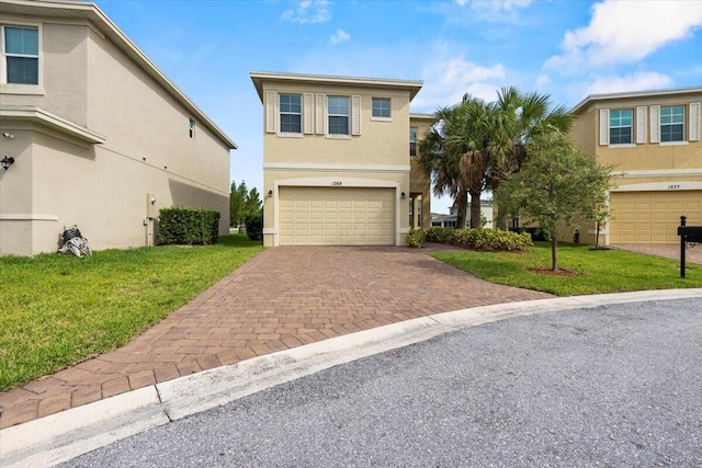 view of property with a front yard and a garage