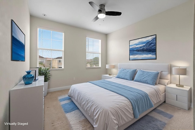 bedroom featuring ceiling fan and light carpet