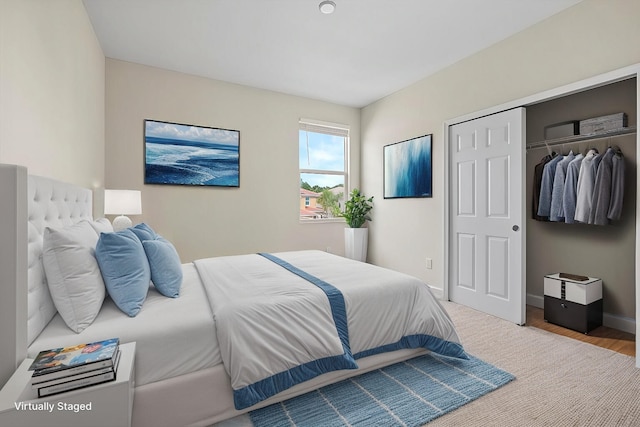 bedroom with hardwood / wood-style floors and a closet