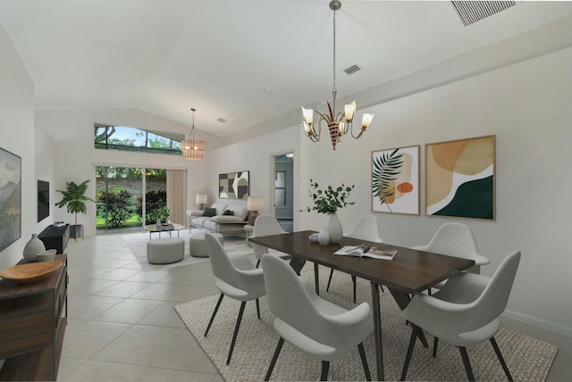 dining area featuring lofted ceiling, light tile patterned floors, and an inviting chandelier