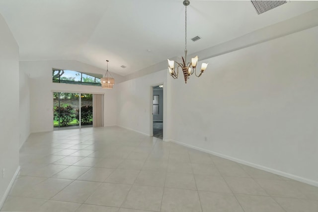 tiled spare room featuring lofted ceiling and a chandelier