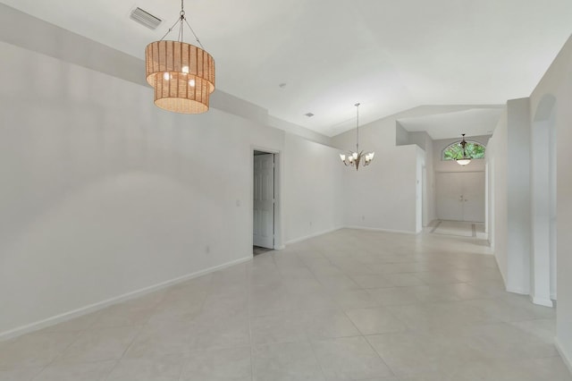 spare room featuring light tile patterned floors, a chandelier, and lofted ceiling