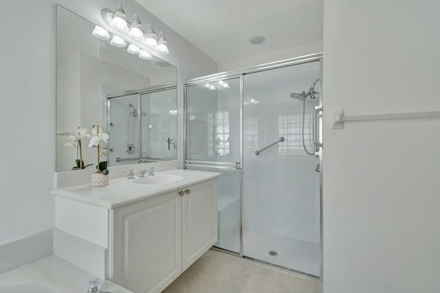 bathroom featuring vanity, tile patterned floors, and walk in shower