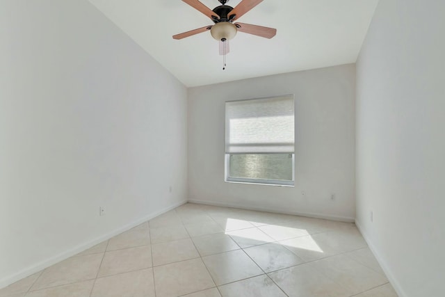 tiled spare room featuring ceiling fan