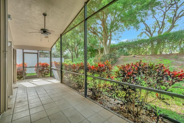 unfurnished sunroom featuring ceiling fan and vaulted ceiling