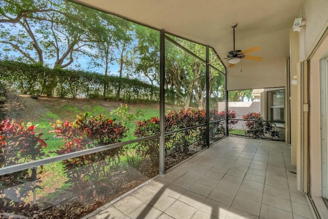 unfurnished sunroom featuring vaulted ceiling and ceiling fan