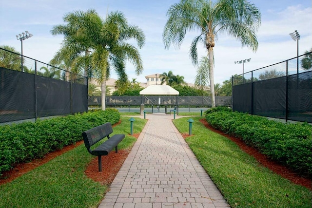 view of home's community with tennis court