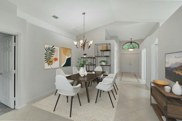 dining space featuring light tile patterned floors, an inviting chandelier, and lofted ceiling