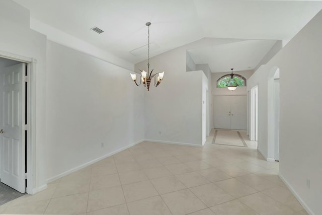 interior space featuring light tile patterned flooring, lofted ceiling, and an inviting chandelier