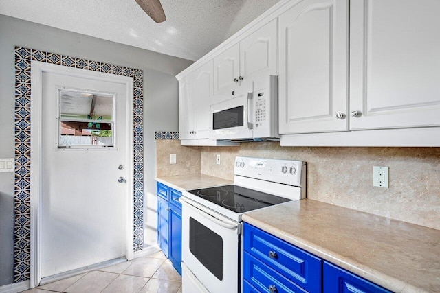 kitchen featuring a textured ceiling, white cabinetry, white appliances, and blue cabinets