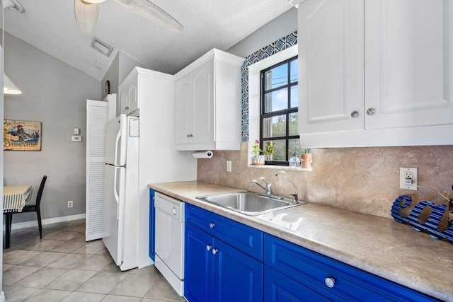 kitchen featuring white appliances, sink, ceiling fan, light tile patterned floors, and blue cabinetry