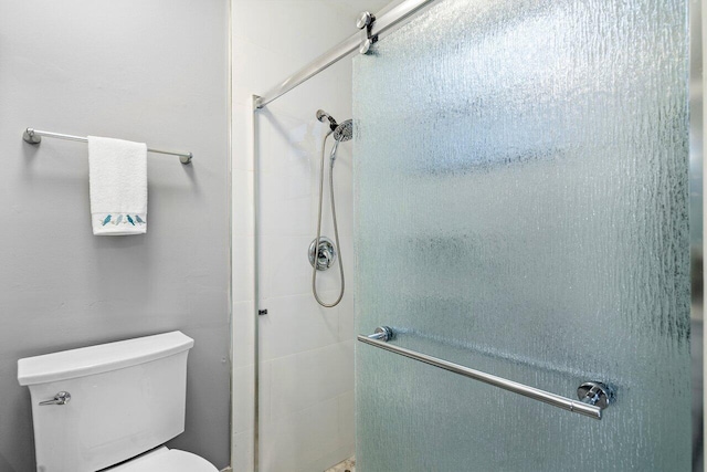 bathroom with toilet and walk in shower