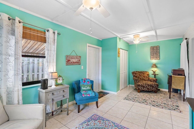 living area with ceiling fan and light tile patterned flooring