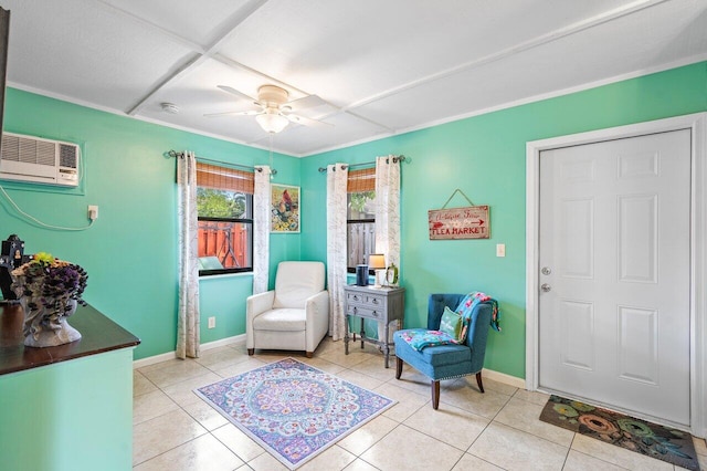 living area featuring light tile patterned floors, a wall unit AC, and ceiling fan