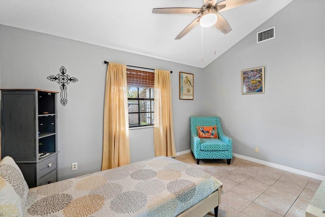 tiled bedroom featuring a textured ceiling, ceiling fan, and lofted ceiling