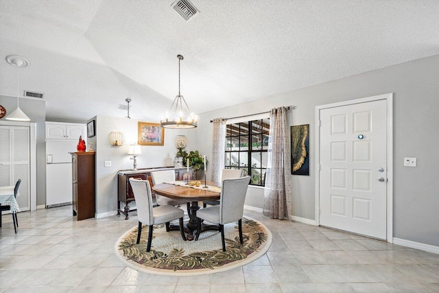 dining area with a notable chandelier and vaulted ceiling