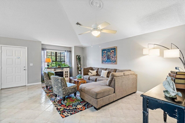 living room with a textured ceiling, vaulted ceiling, and ceiling fan