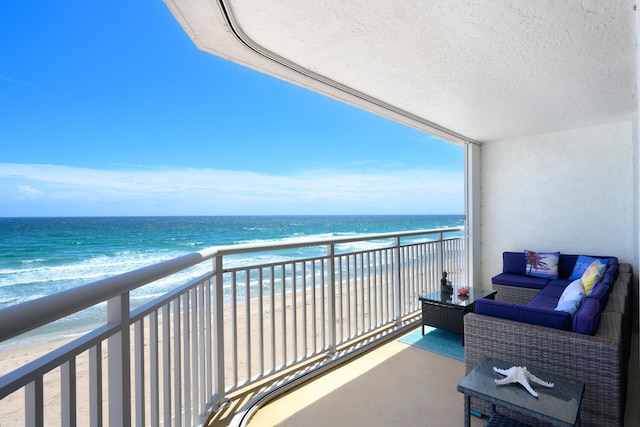 balcony with a beach view and a water view