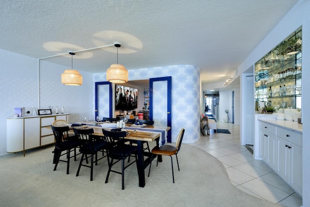 dining room with light tile patterned floors and a textured ceiling