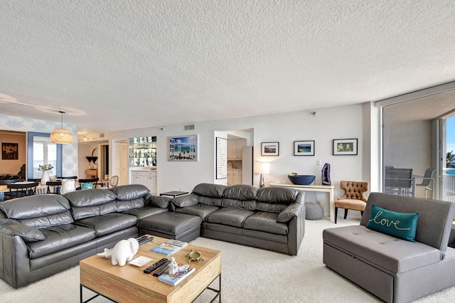 living room with light carpet and a textured ceiling