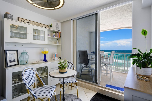 tiled dining room featuring a water view