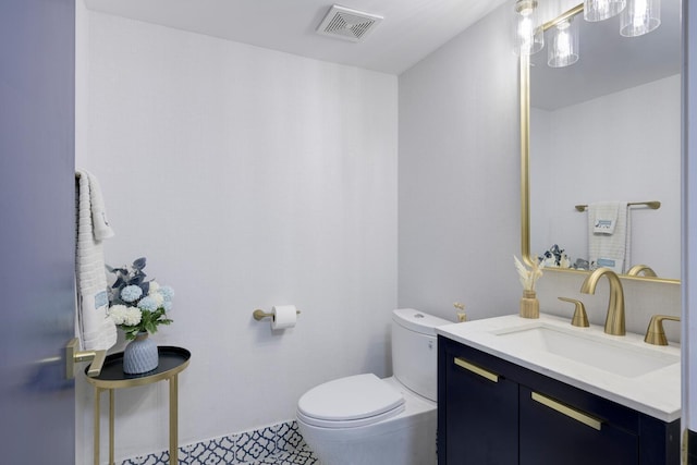 bathroom with tile patterned floors, vanity, and toilet