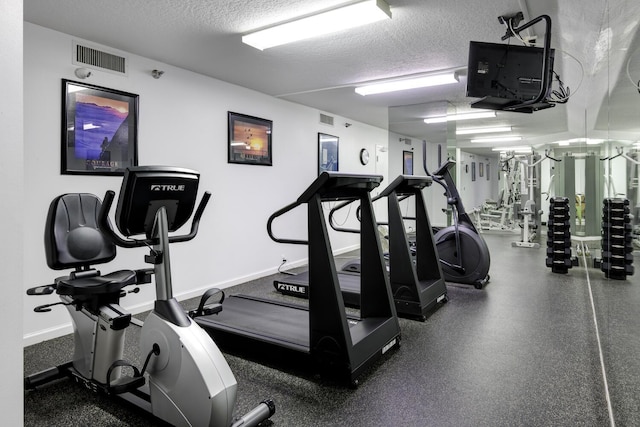 gym with a textured ceiling